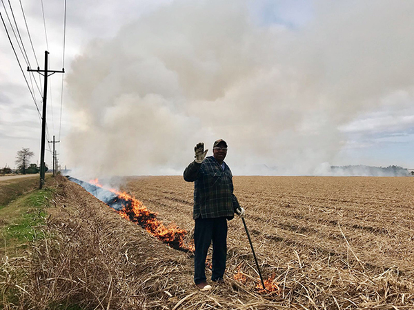 يعمد المزارعون غالبًا إلى إضرام النار في الحقول الزراعية لتنقيتها وتطهيرها، لكن هذه الممارسة تزيد من تلوث الهواء. توضح هذه الصورة رجلًا يشعل حريقًا في حقلٍ بلويزيانا. تصوير: Chloe Gao