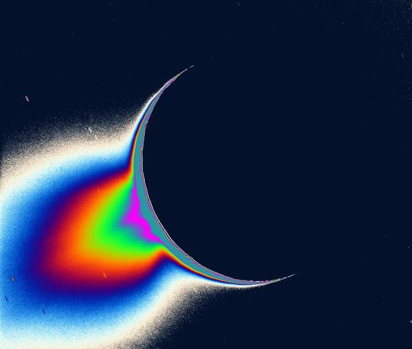 تُظهر صورُ كاسيني للجزءِ الخلفيّ المضاءِ بالشمس للقمر إنسيلادوس، مصادرَ الرذاذِ الناعم من المواد والشبيه بالنافورة يعلو فوق منطقة القطب الجنوبي للقمر.