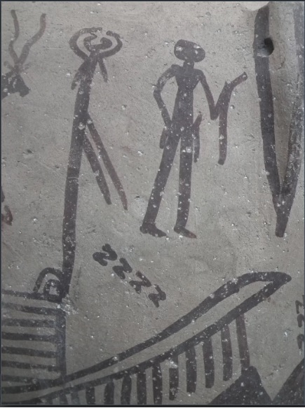 صورة طقس عشائري مرسومة على جرة فخارية من عصر ما قبل الأسرات. لاحظ الخطوط ذات شكل S (التي تبدو كحرف z) والشيء الطولي المُقوس بيد الرجل.